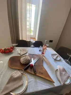 a table with a wooden cutting board with a knife at NEW G&P Villa - Free Parking in Ljubljana