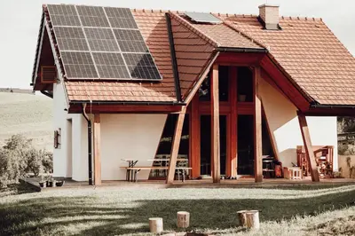 a house with solar panels on the roof at Ecological farm Makrobios Panonija in Gornji Petrovci