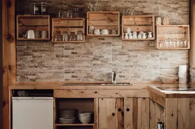 a kitchen with wooden cabinets and a sink at Ecological farm Makrobios Panonija in Gornji Petrovci