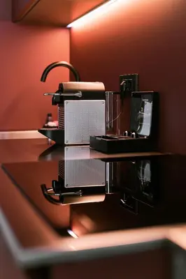 a counter with a coffee maker and a glass on it at NEU RESIDENCES smart stay in Ljubljana