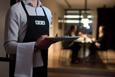 a man holding a plate of food in his hand at NEU RESIDENCES smart stay in Ljubljana
