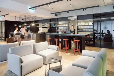 a restaurant with white chairs and a bar at NEU RESIDENCES smart stay in Ljubljana
