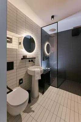 a bathroom with a toilet and a sink and a shower at NEU RESIDENCES smart stay in Ljubljana