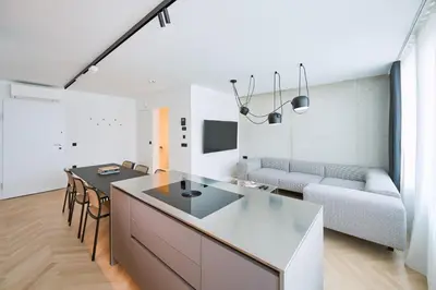a kitchen and living room with a table and a couch at NEU RESIDENCES smart stay in Ljubljana