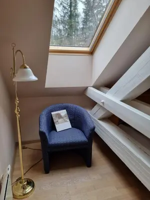 a room with a blue chair and a window at Apartma Vrtnica, Vila Golf in Rogaška Slatina