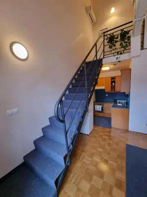 a staircase in a room with a kitchen at Apartma Vrtnica, Vila Golf in Rogaška Slatina