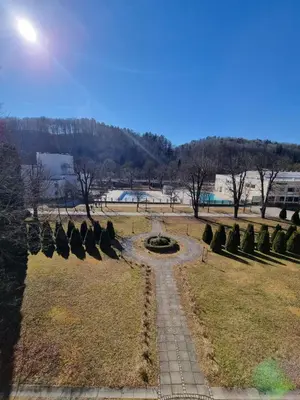 a park with a fountain in the middle of a field at Apartma Vrtnica, Vila Golf in Rogaška Slatina
