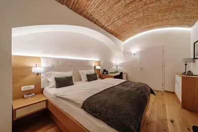 a bedroom with a large bed with a brick ceiling at Operna klet Ljubljana in Ljubljana
