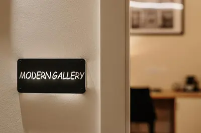 a door with a sign that reads modern gallery at Operna klet Ljubljana in Ljubljana