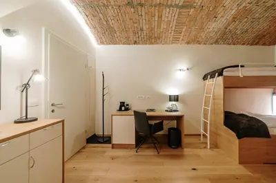 a bedroom with a desk and a bunk bed at Operna klet Ljubljana in Ljubljana