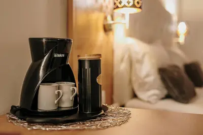 a coffee maker and two cups on a table at Operna klet Ljubljana in Ljubljana
