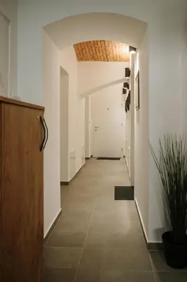 a hallway with white walls and a ceiling at Operna klet Ljubljana in Ljubljana