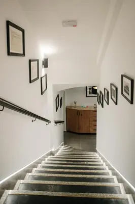 a staircase in a building with pictures on the walls at Operna klet Ljubljana in Ljubljana