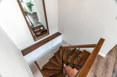a stairwell with a mirror and a chair at Entire house in the center of Ljubljana - FREE PARKING - Dragon Garden Pavilion Ljubljana in Ljubljana