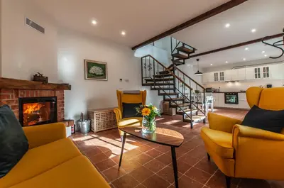 a living room with yellow furniture and a fireplace at Entire house in the center of Ljubljana - FREE PARKING - Dragon Garden Pavilion Ljubljana in Ljubljana