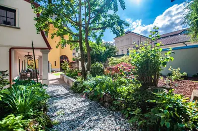 a garden of flowers and plants in front of a house at Entire house in the center of Ljubljana - FREE PARKING - Dragon Garden Pavilion Ljubljana in Ljubljana