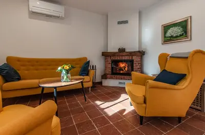 a living room with yellow chairs and a fireplace at Entire house in the center of Ljubljana - FREE PARKING - Dragon Garden Pavilion Ljubljana in Ljubljana