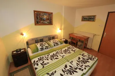 a bedroom with a bed and a desk in it at Rooms Pekovec Bohinj in Bohinj