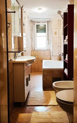 a bathroom with a tub and a sink and a toilet at Quiet Central in Ljubljana