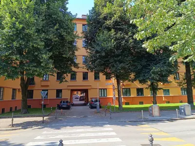 an orange building with trees in front of it at Quiet Central in Ljubljana