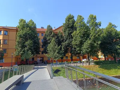 a walkway in front of a building with trees at Quiet Central in Ljubljana
