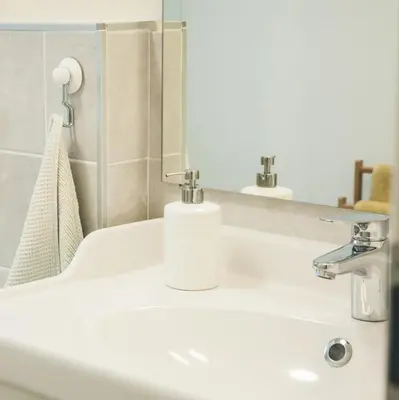 a bathroom with a white sink and a mirror at Apartmaji Aucin - Brda in Kojsko