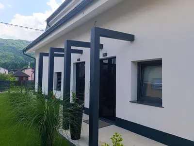 a white house with blue paint on it at Apartma FRIGO in Maribor