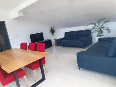 a living room with a table and chairs and a couch at Apartma FRIGO in Maribor