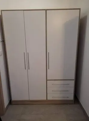 a closet with two white cabinets in a room at Apartma Uhanje pri Božičevih in Ajdovščina
