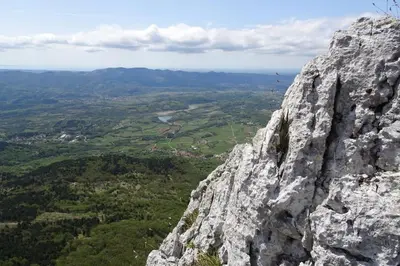 a view of a large rocky mountain with a valley at Apartma Uhanje pri Božičevih in Ajdovščina