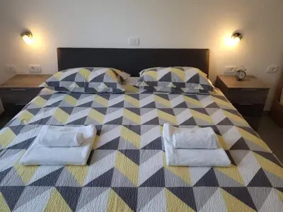 a bedroom with a large bed with towels on it at Apartma Uhanje pri Božičevih in Ajdovščina