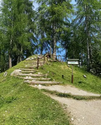 a path on a hill with a sign on it at Erjavčeva mountain hut at Vršič pass in Kranjska Gora