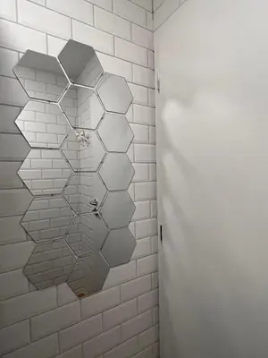 a bathroom with a wall covered in white tiles at Erjavčeva mountain hut at Vršič pass in Kranjska Gora