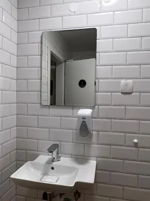 a white bathroom with a sink and a mirror at Erjavčeva mountain hut at Vršič pass in Kranjska Gora