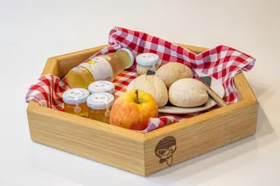 a wooden crate filled with food and drinks and an apple at Honeybee Hostel - Hiša kranjske čebele in Višnja Gora
