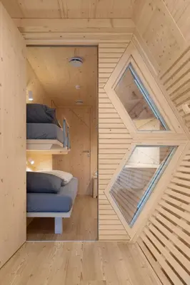 a room with two bunk beds and a window at Honeybee Hostel - Hiša kranjske čebele in Višnja Gora