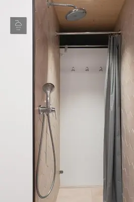 a shower in a bathroom with a shower curtain at Honeybee Hostel - Hiša kranjske čebele in Višnja Gora