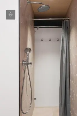 a shower in a bathroom with a shower curtain at Honeybee Hostel - Hiša kranjske čebele in Višnja Gora