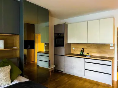 a kitchen with white cabinets and a counter top at Oasis of Energy in Ljubljana