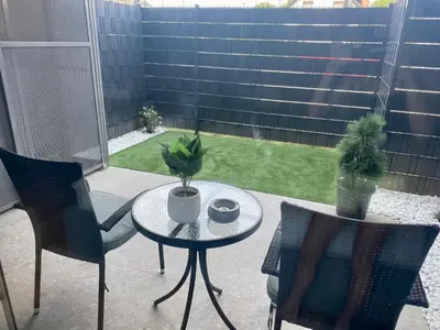 a patio with a table and chairs and plants at Oasis of Energy in Ljubljana