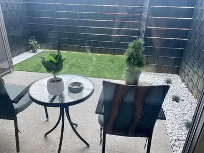 a patio with a table and chairs and plants at Oasis of Energy in Ljubljana