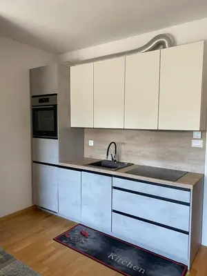 a kitchen with white cabinets and a sink at Oasis of Energy in Ljubljana
