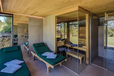 a room with green chairs and a glass wall at Winzarei Ciringa Menhard in Zgornja Kungota
