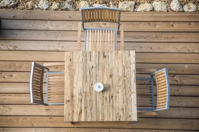 a wooden wall with two chairs and a table at Winzarei Ciringa Menhard in Zgornja Kungota