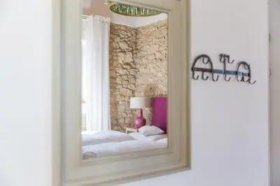 a mirror in a room with a bed and a window at Winzarei Ciringa Menhard in Zgornja Kungota