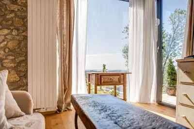 a room with a bed and a large window at Winzarei Ciringa Menhard in Zgornja Kungota