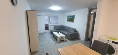 a living room with a couch and a table at Apartma Sivi žako in Bohinj