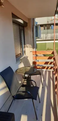 a patio with a table and chairs on a balcony at Apartma Sivi žako in Bohinj