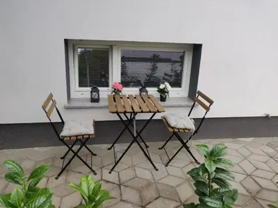 a table and two chairs in front of a window at Cozy Little Apartments in Ig