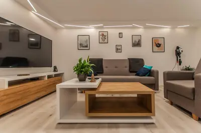 a living room with a couch and a tv at Cozy Little Apartments in Ig